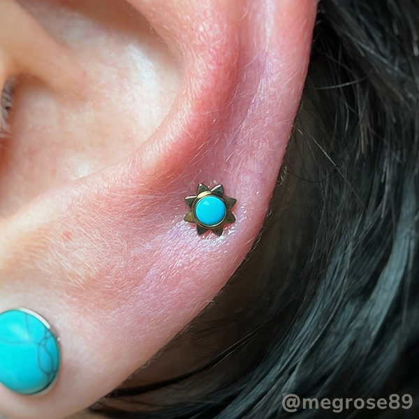 Mid-helix piercing of an anodized Sun Cabochon end with a Turquoise stone
