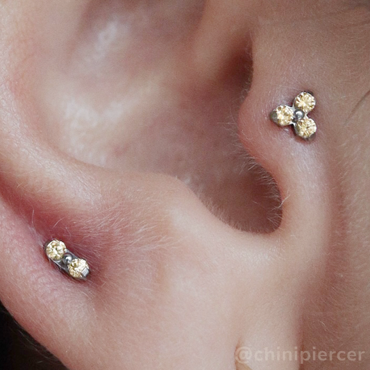 A 2mm and 1.5mm threadless titanium end with three cubic zirconia gems set around a titanium center.