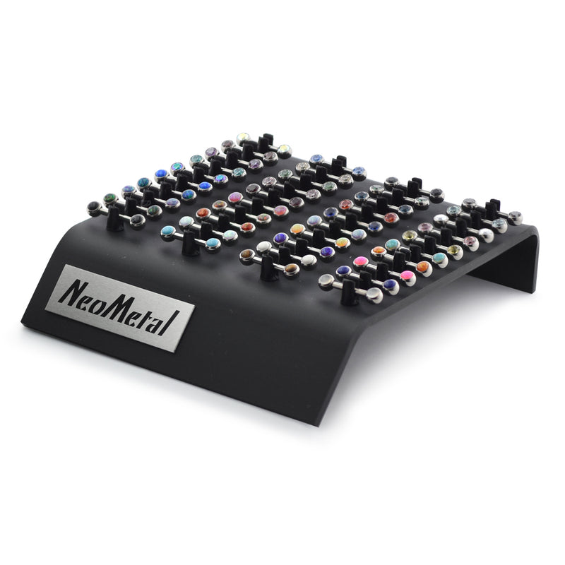 A 40 piece acrylic display case with the NeoMetal logo and versi-clip grips. The versi clips hold threadless titanium nipple bars with a variety of colored gem ends.