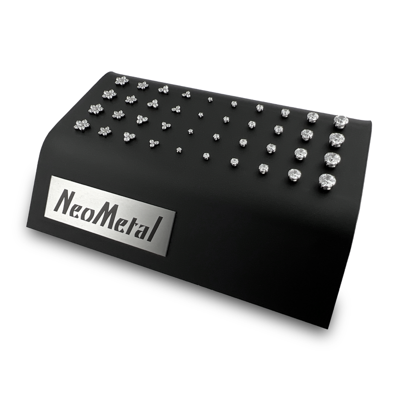 A 40 unit black display case showcasing different sizes of our titanium prong set gem ends with cubic zirconia and different sizes of our titanium flower and trinity gem ends with cubic zirconia