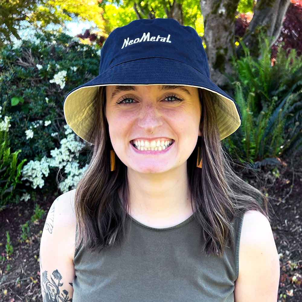 Woman wearing Navy Bucket Hat with NeoMetal Logo