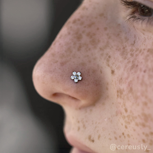 A 2mm and 1.5mm threadless titanium flower end, with five cubic zirconia faceted gems set around a titanium center