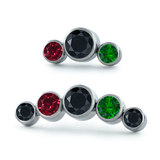 A 3-Piece and 5-Piece Curver Titanium Bezel Set Gem Cluster featuring Emerald, Ruby, and Black Faceted Gems