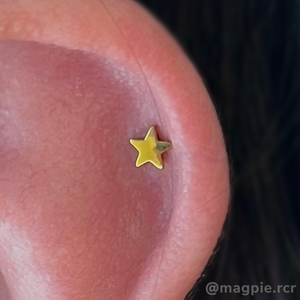 Yellow anodized Stellar End in helix piercing