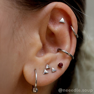 Titanium Triangles featured in an ear curation.