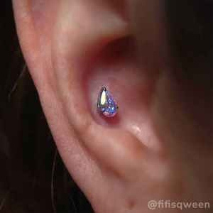 Conch piercing with prong set Aurora Borealis Pear cut gem 
