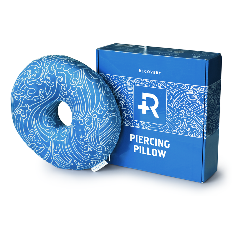 Blue Piercing Pillow with white wave outlines and box