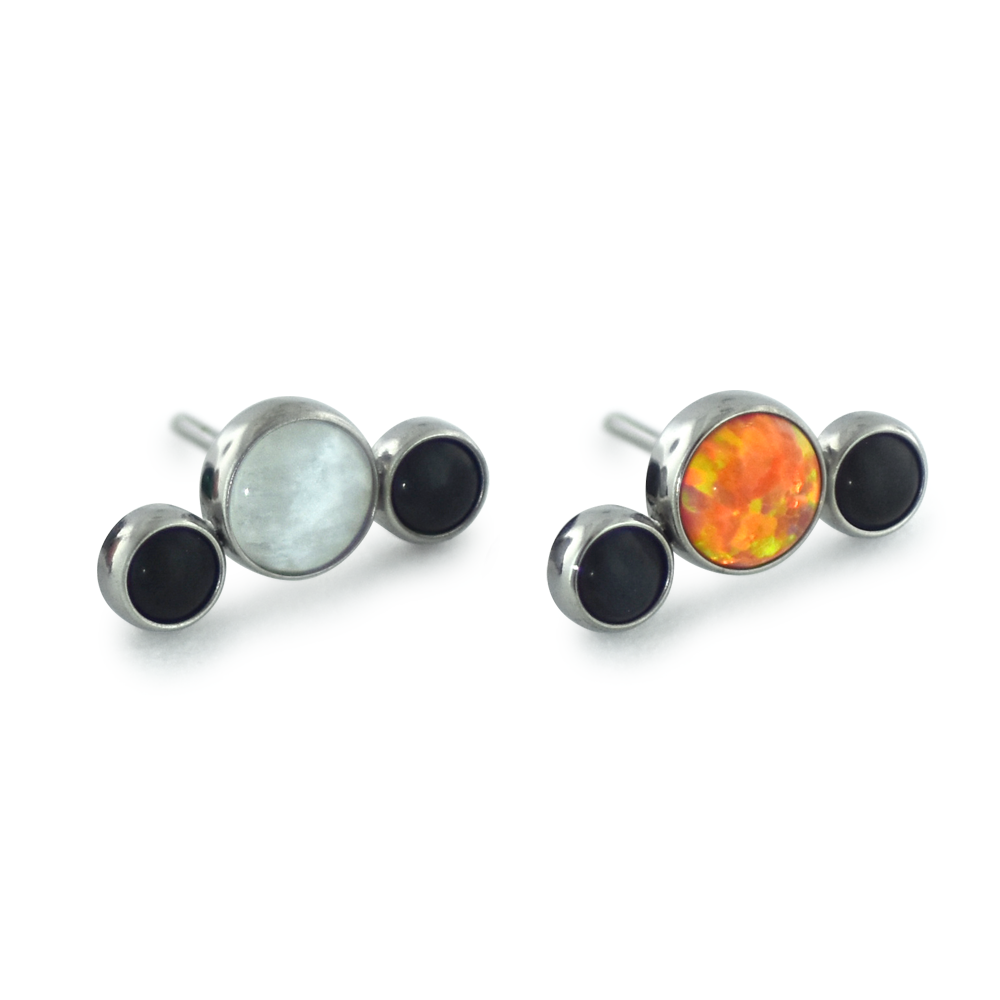 Two 3-piece threadless titanium cabochon cluster ends, one featuring moonstone and onyx cabochons while the other features orange and onyx cabochons.