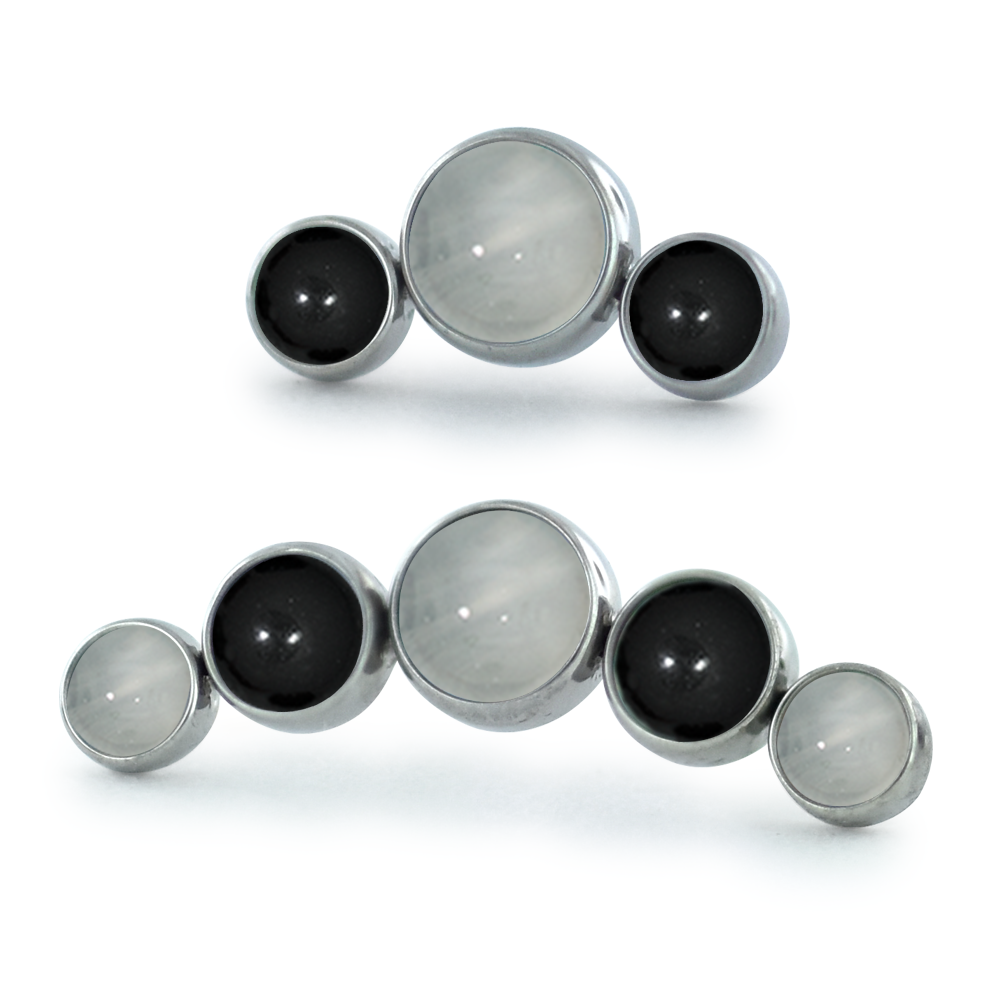 A 3-piece and 5-piece titanium curved cabochon cluster with onyx and moonstone cabochons