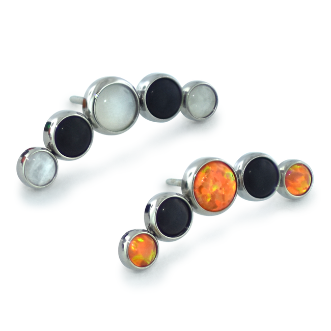 Two 5-piece threadless titanium cabochon cluster ends, one featuring moonstone and onyx cabochons while the other features orange and onyx cabochons.
