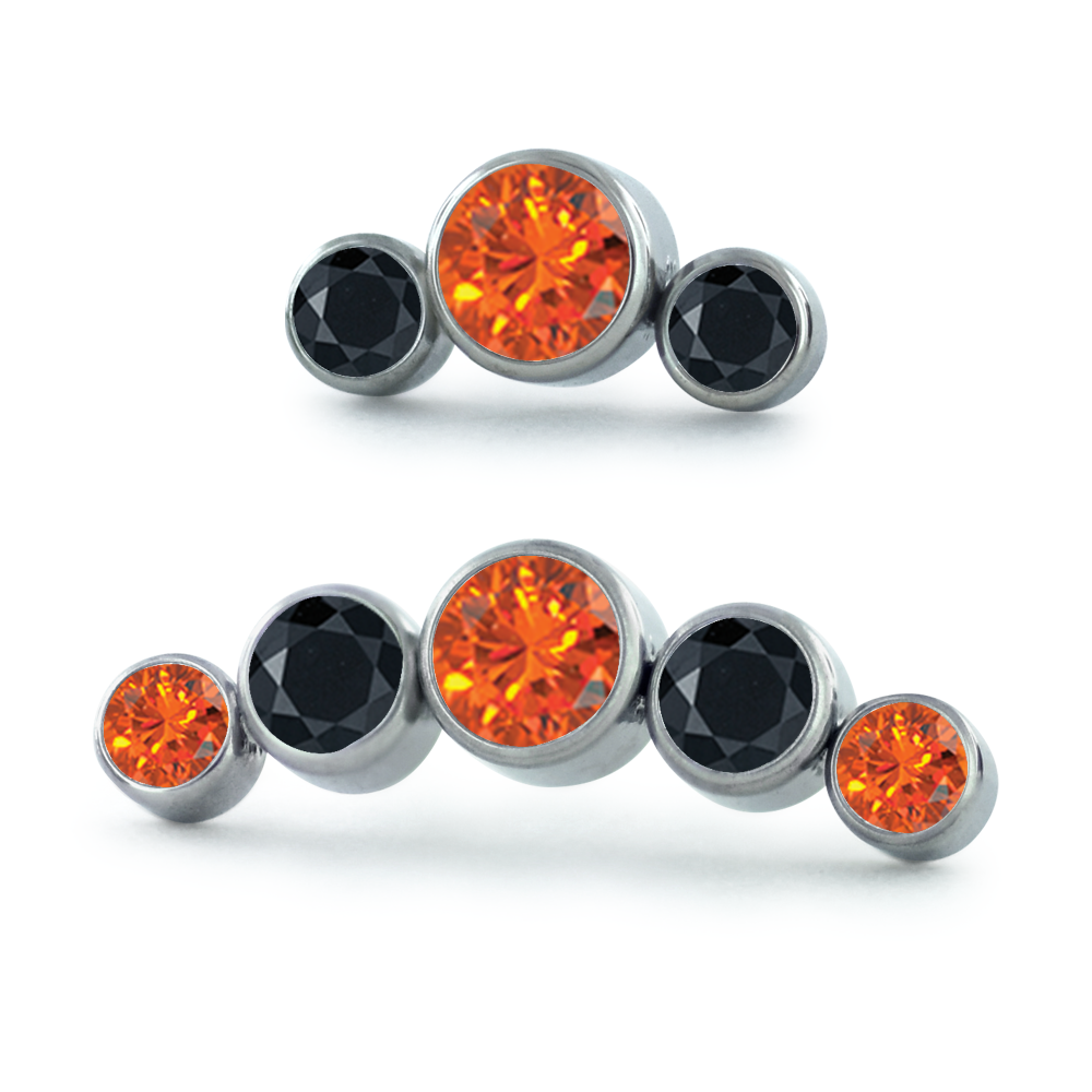 A 3-piece and 5-piece titanium curved cluster with orange and black gems