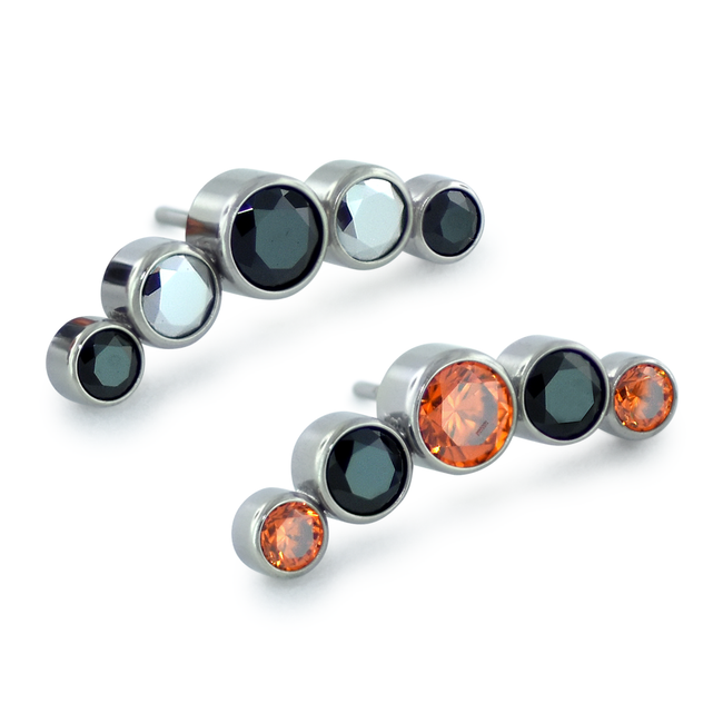 Two 5-piece threadless titanium gem cluster ends, one featuring light chrome and black gems while the other features orange and black gems.