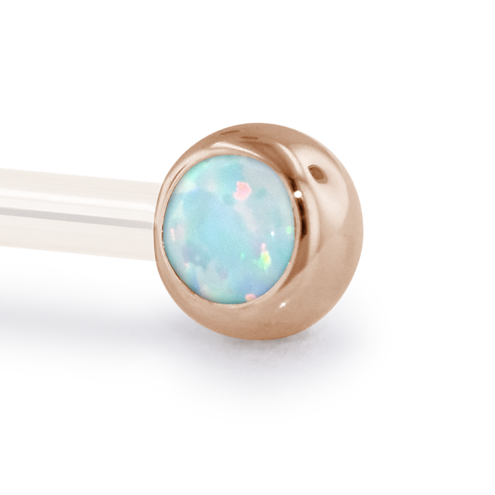 A 14 Gauge side gem in Rose Gold with a White Opal Cabochon