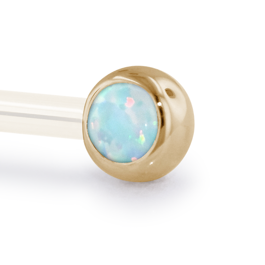 A 12 Gauge side gem in Yellow Gold with a White Opal Cabochon