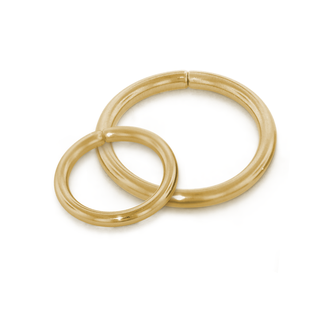 Two of our 16 gauge 18 karat gold seam rings overlapping, all in yellow gold
