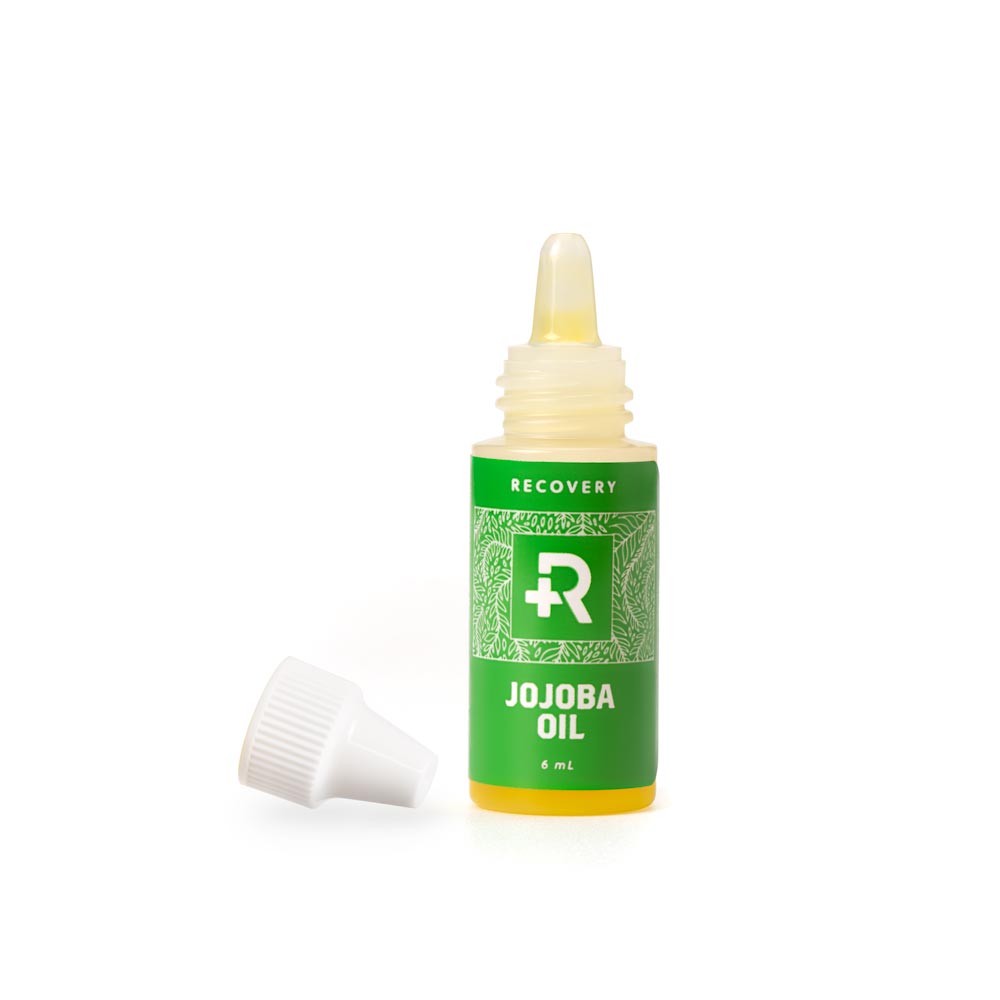 Uncapped jojoba oil bottle