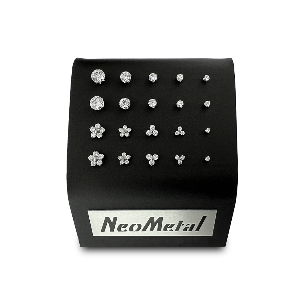 A 20 unit black display case showcasing different sizes of our titanium prong set gem ends with cubic zirconia and different sizes of our titanium flower and trinity gem ends with cubic zirconia